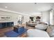 Open-concept living room boasts hardwood floors, neutral paint, and a cozy sectional sofa at 156 Marchmont Dr, Locust Grove, GA 30248