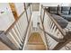 Stylish staircase showcases carpeted steps, wooden handrails, and a view of the living space at 156 Marchmont Dr, Locust Grove, GA 30248
