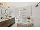 Bright bathroom with a luxurious soaking tub, double vanity, and modern fixtures at 770 Reed Se St, Atlanta, GA 30315