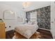 Comfortable bedroom with floral accent wall, natural light and dark wood floors at 770 Reed Se St, Atlanta, GA 30315