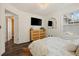 Bedroom featuring natural light, wood floors, tv, and stylish wooden dresser at 770 Reed Se St, Atlanta, GA 30315