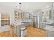 Bright kitchen features custom gray cabinets, a large island with seating, and stainless steel appliances at 770 Reed Se St, Atlanta, GA 30315