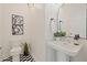 Stylish powder room with black and white tile floor, pedestal sink, and modern fixtures at 770 Reed Se St, Atlanta, GA 30315