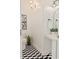Stylish powder room with black and white tile floor, pedestal sink, and modern fixtures at 770 Reed Se St, Atlanta, GA 30315