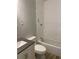 Bathroom features a tub, toilet and modern sink with a gray countertop at 8154 Tudor Dr, Jonesboro, GA 30238