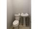 Cozy half bath featuring a pedestal sink and standard white toilet at 8154 Tudor Dr, Jonesboro, GA 30238