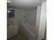 Bathroom with a vanity, shower, and tiled walls at 8154 Tudor Dr, Jonesboro, GA 30238