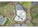 Aerial view of the community pool with landscaping, pool furniture, and a clubhouse at 1077 Mainstreet Valley Dr, Stone Mountain, GA 30088