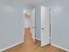 Bedroom with light blue walls and wood-look floors with open closet doors at 1077 Mainstreet Valley Dr, Stone Mountain, GA 30088