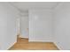 Bedroom with light wood floors, a white wall, and entry to another room at 1077 Mainstreet Valley Dr, Stone Mountain, GA 30088