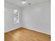 Well-lit bedroom with natural light and laminate wood flooring at 1077 Mainstreet Valley Dr, Stone Mountain, GA 30088