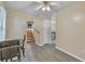 Bright dining room featuring modern vinyl floors, a ceiling fan, and views of a stone fireplace at 1077 Mainstreet Valley Dr, Stone Mountain, GA 30088