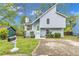 Charming two-story home featuring light blue siding, green front door, tidy landscaping, and a welcoming front yard at 1077 Mainstreet Valley Dr, Stone Mountain, GA 30088
