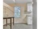 Bright breakfast nook featuring modern vinyl floors, a window, and white cabinets with granite countertops at 1077 Mainstreet Valley Dr, Stone Mountain, GA 30088