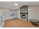 Spacious living room with a stone fireplace and hardwood floors at 1077 Mainstreet Valley Dr, Stone Mountain, GA 30088