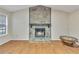 Bright living room featuring wood floors, a stone fireplace, and a large window, providing ample natural light at 1077 Mainstreet Valley Dr, Stone Mountain, GA 30088