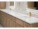 Luxurious bathroom featuring double vanity, marble countertops, and gold faucet at 1688 Mineral Springs Rd, Hoschton, GA 30548