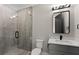 Modern bathroom features glass shower enclosure, neutral wall coloring, and granite vanity top at 1688 Mineral Springs Rd, Hoschton, GA 30548
