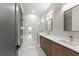 Luxurious bathroom with a dual vanity, frameless glass shower, and marble floors and walls at 1688 Mineral Springs Rd, Hoschton, GA 30548