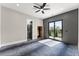 Bedroom with sliding doors to backyard, dark accent wall, and entry to ensuite at 1688 Mineral Springs Rd, Hoschton, GA 30548