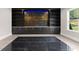 Bonus room with custom built-in shelves, stylish cabinets, and a large window at 1688 Mineral Springs Rd, Hoschton, GA 30548
