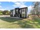 A modern home with a symmetrical design, a spacious lawn, and professional landscaping at 1688 Mineral Springs Rd, Hoschton, GA 30548