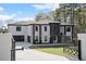 Beautiful new construction home featuring white brick, black trim, and a spacious two-car garage at 1688 Mineral Springs Rd, Hoschton, GA 30548