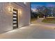 Modern exterior door with sidelights and matching lights from the driveway at 1688 Mineral Springs Rd, Hoschton, GA 30548