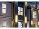 Close up on the exterior with modern lighting and brick detail on a two-story home at 1688 Mineral Springs Rd, Hoschton, GA 30548