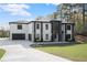 Newly built modern home with large garage, professional landscaping, and a well-manicured lawn at 1688 Mineral Springs Rd, Hoschton, GA 30548