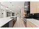 Modern kitchen featuring granite countertops, stainless steel appliances, and black marble backsplash at 1688 Mineral Springs Rd, Hoschton, GA 30548