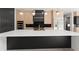Modern kitchen island featuring a white countertop, black base, and stainless steel appliances at 1688 Mineral Springs Rd, Hoschton, GA 30548