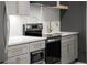 Updated kitchen featuring gray cabinets, gold hardware, and stainless steel appliances at 1688 Mineral Springs Rd, Hoschton, GA 30548