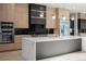 Modern kitchen with stainless steel appliances, custom cabinets, and a large island at 1688 Mineral Springs Rd, Hoschton, GA 30548