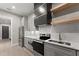 Modern kitchen featuring gray cabinets, stainless appliances, and stylish backsplash at 1688 Mineral Springs Rd, Hoschton, GA 30548