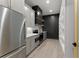 Modern kitchen with stainless steel appliances, gray cabinets, hardwood floors, and gold hardware at 1688 Mineral Springs Rd, Hoschton, GA 30548