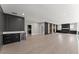Spacious living room featuring hardwood floors, dark wood accent walls, and a wet bar at 1688 Mineral Springs Rd, Hoschton, GA 30548