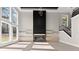 Bright, open living room featuring a modern fireplace, large windows, and light hardwood floors at 1688 Mineral Springs Rd, Hoschton, GA 30548
