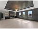 Spacious living room with fireplace, custom cabinets, three picture windows and hardwood flooring at 1688 Mineral Springs Rd, Hoschton, GA 30548