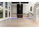 Bright, open living room featuring a modern fireplace, large windows, and light hardwood floors at 1688 Mineral Springs Rd, Hoschton, GA 30548