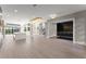 Spacious living room featuring hardwood floors, modern lighting, and an entertainment center at 1688 Mineral Springs Rd, Hoschton, GA 30548