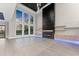 Spacious living room with a modern fireplace, large windows offering scenic views, and elegant flooring at 1688 Mineral Springs Rd, Hoschton, GA 30548