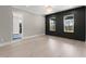 Living room with hardwood floors, shiplap accent wall with windows, and elegant lighting at 1688 Mineral Springs Rd, Hoschton, GA 30548