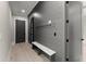 Well-organized mudroom featuring coat hooks, a bench, and stylish design at 1688 Mineral Springs Rd, Hoschton, GA 30548