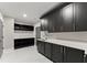 Mudroom area with black cabinets, quartz countertops and gold hardware at 1688 Mineral Springs Rd, Hoschton, GA 30548