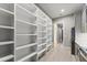 Walk-in pantry with custom shelving for maximum storage, and hardwood floors at 1688 Mineral Springs Rd, Hoschton, GA 30548