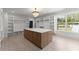 Spacious walk-in closet with custom shelving, island, and large window with abundant natural light at 1688 Mineral Springs Rd, Hoschton, GA 30548