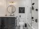 Stylish bathroom with a modern vanity, round mirror, and tiled shower-tub combination at 1850 Cotillion Dr # 2221, Atlanta, GA 30338