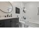 Chic bathroom with a dark vanity, round mirror, and walk-in shower with white tiled walls at 1850 Cotillion Dr # 2221, Atlanta, GA 30338