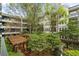 Lush courtyard view featuring pergolas, mature trees and apartment balconies at 1850 Cotillion Dr # 2221, Atlanta, GA 30338